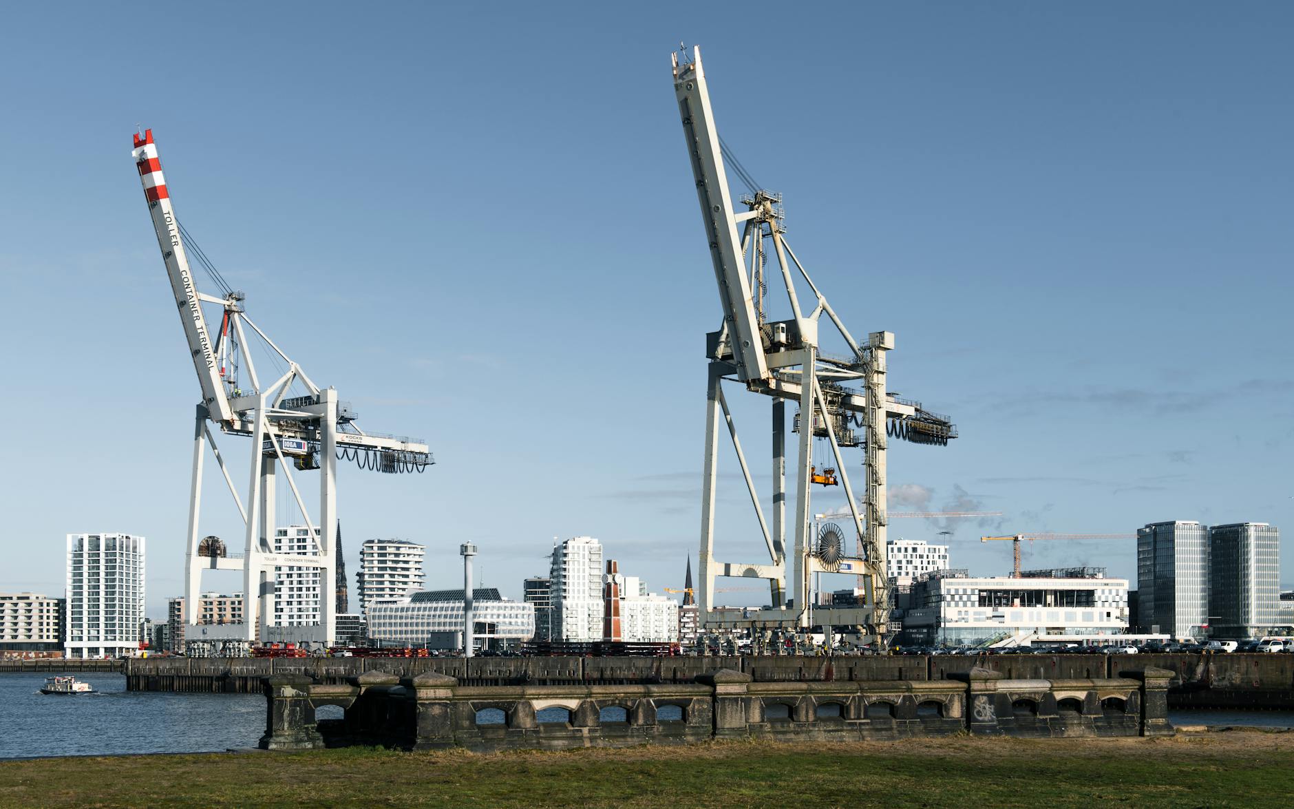 industrial cranes at hamburg port with skyline
