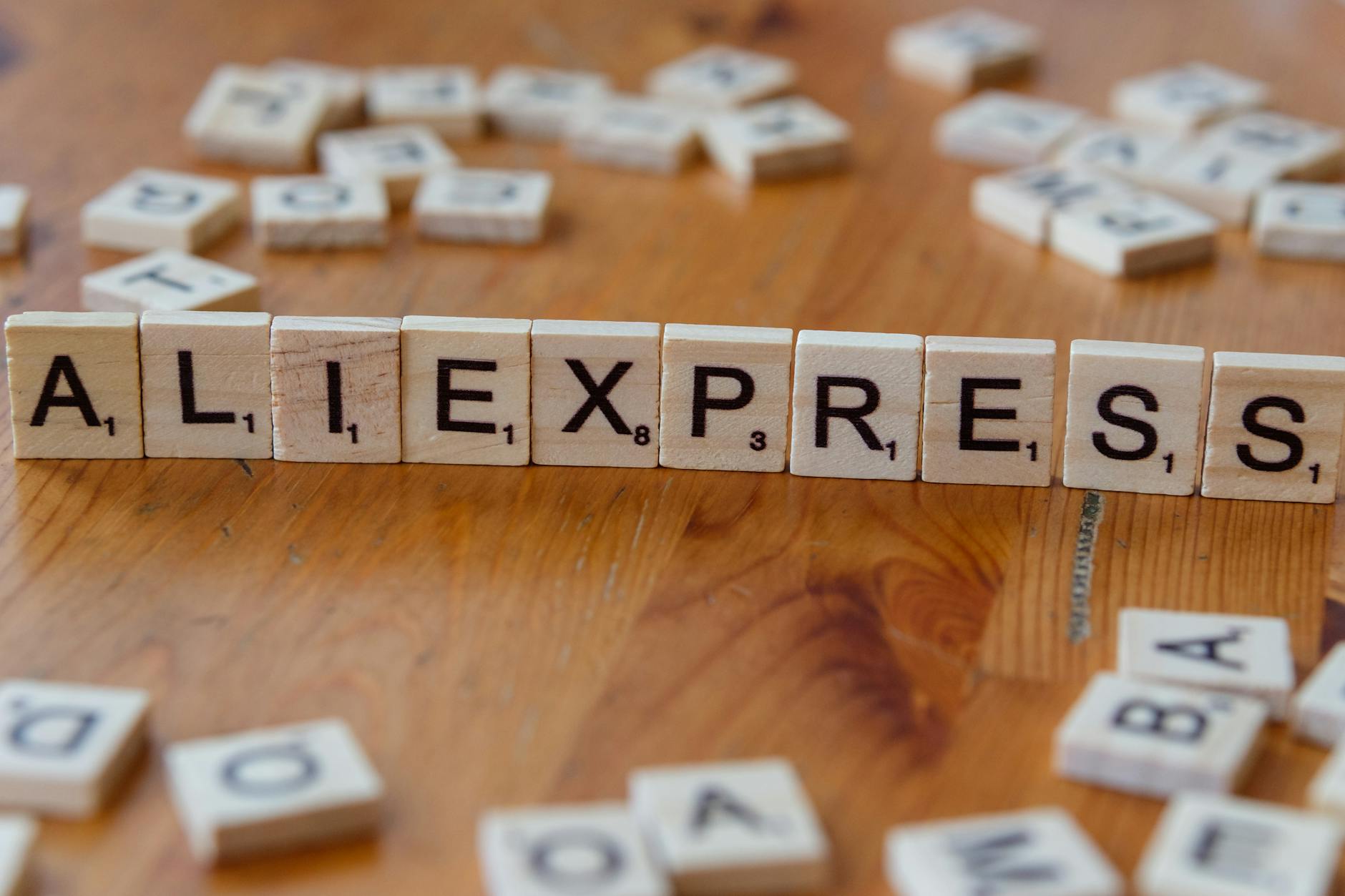 scrabble tiles spelling aliexpress on wooden table