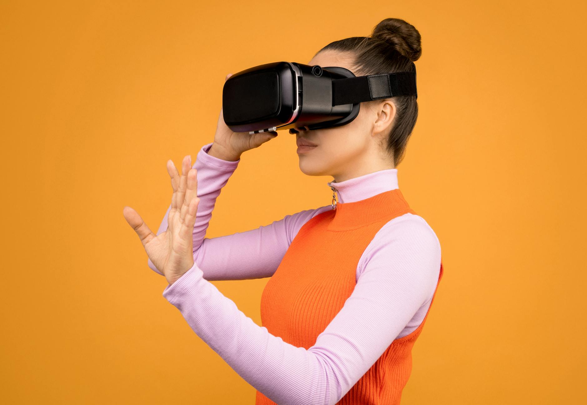 woman adjusting her virtual reality headset
