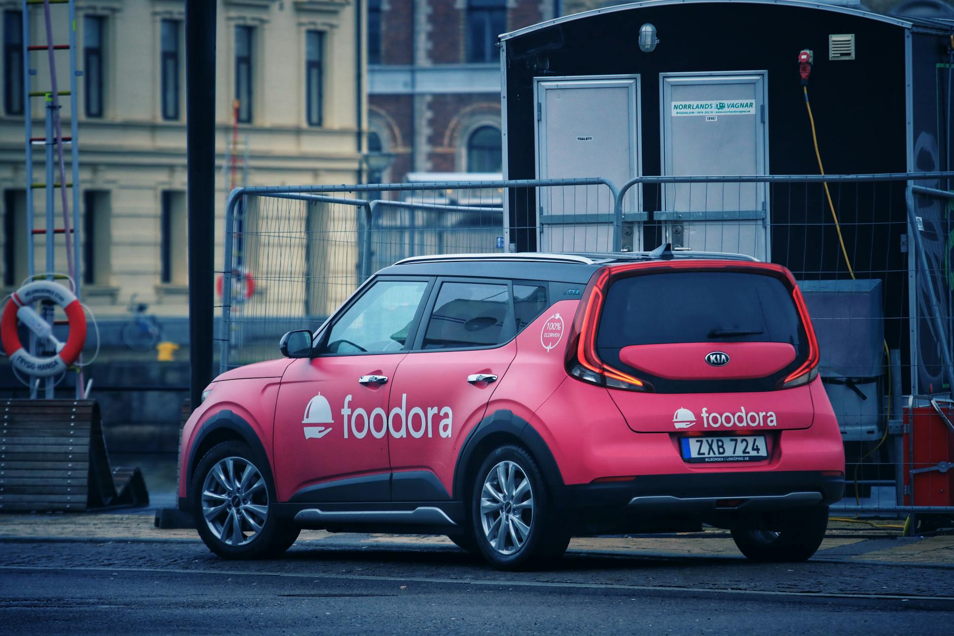 pink kia electric car in the city street