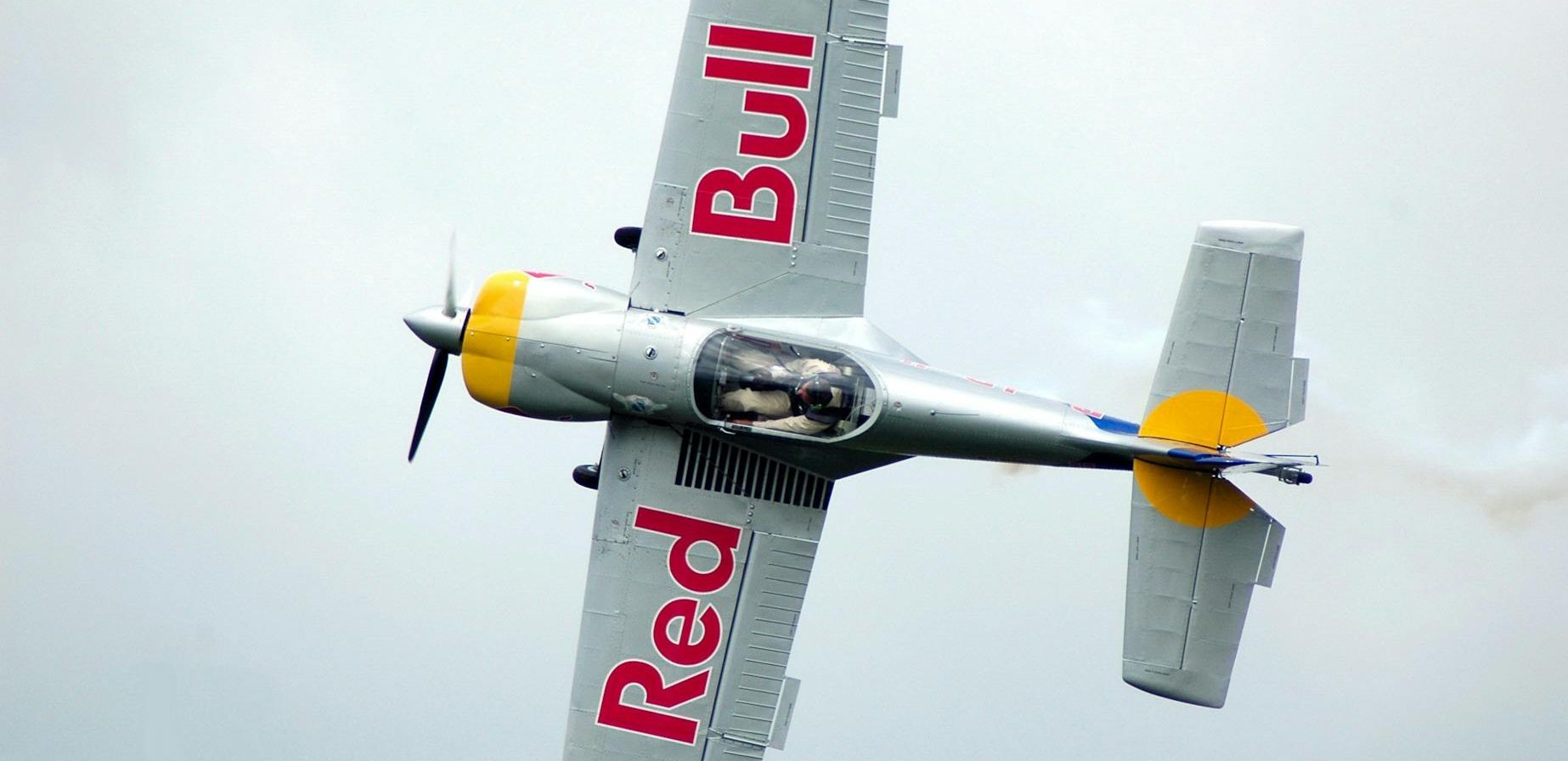 gray red bull monoplane on mid air