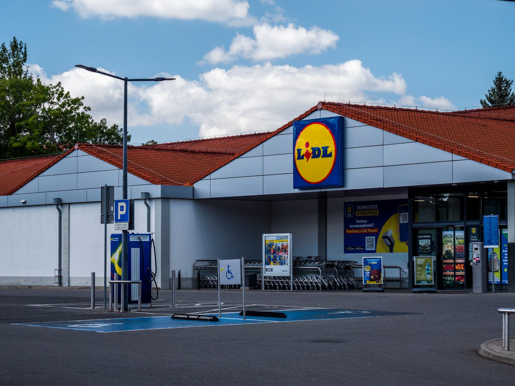 lidl storefront with parking area in summer
