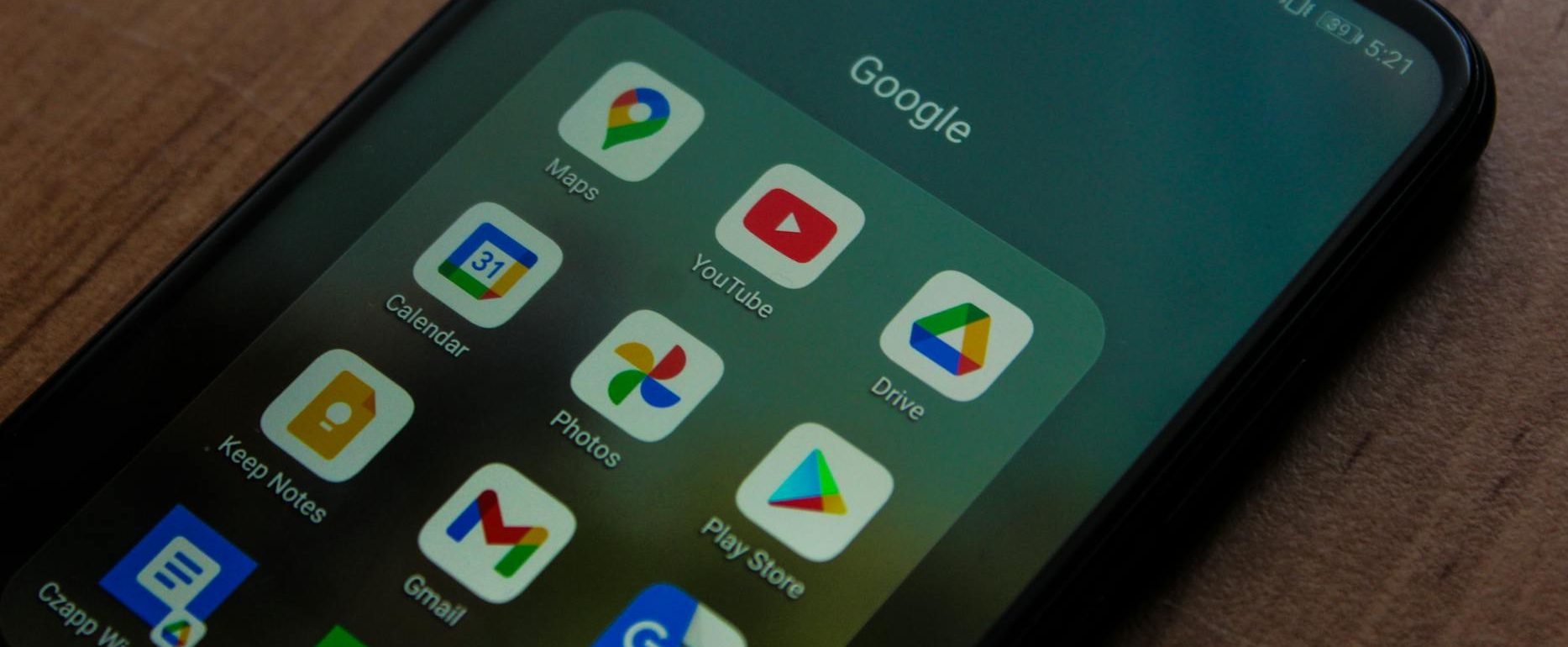 a black android smartphone with google apps on screen