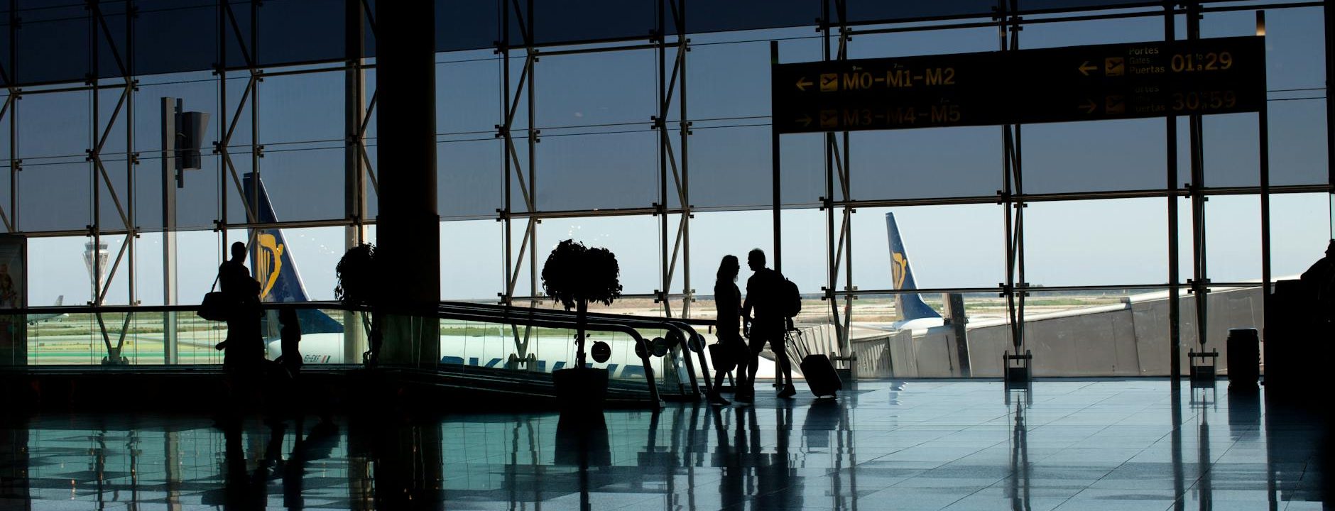 silhouette of people walking at the airport