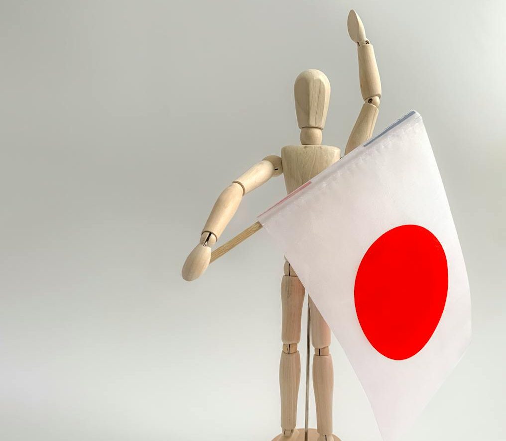 wooden figurine with a japanese flag