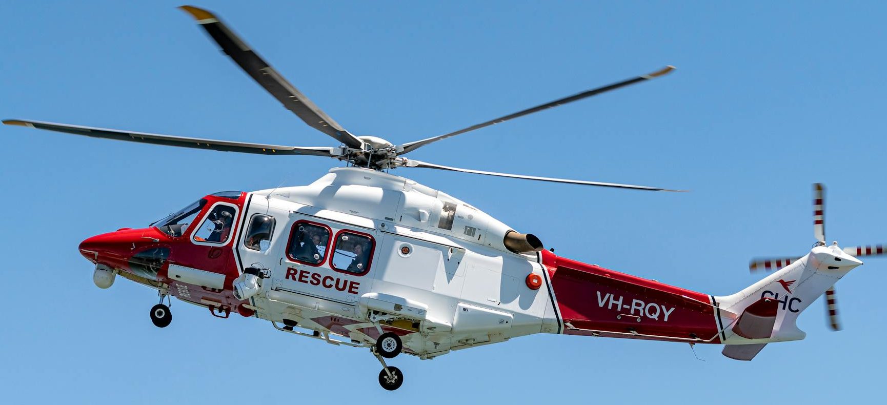 white helicopter flying in the sky