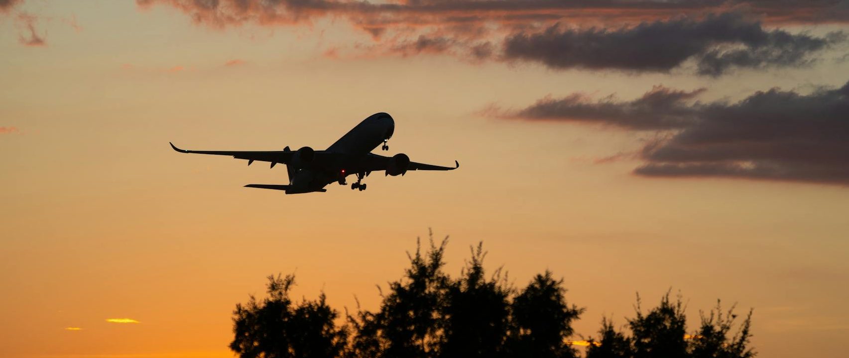 silhouette of an airplane during a sunset
