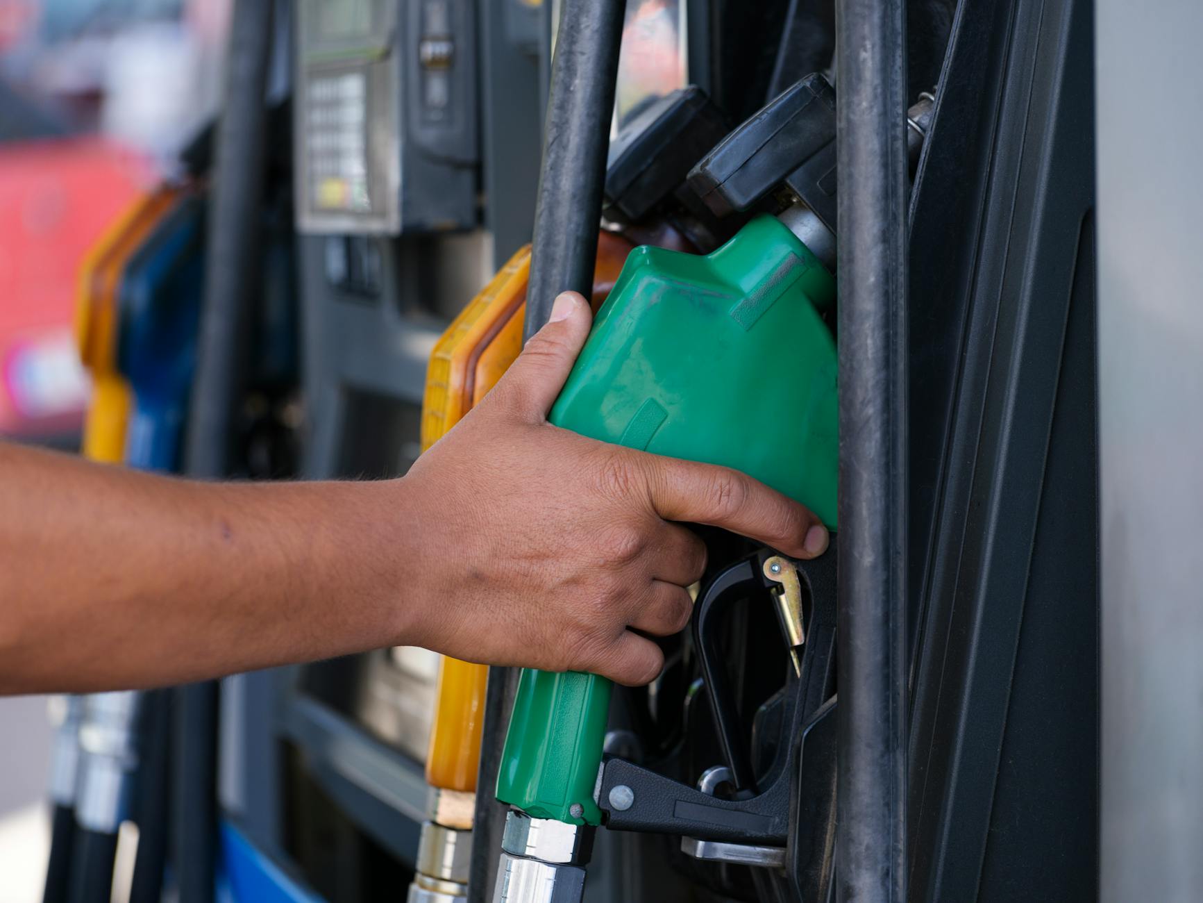 a person s hand holding a gas pump