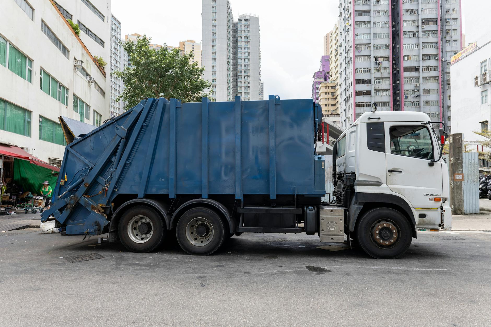 urban garbage truck in bustling city environment