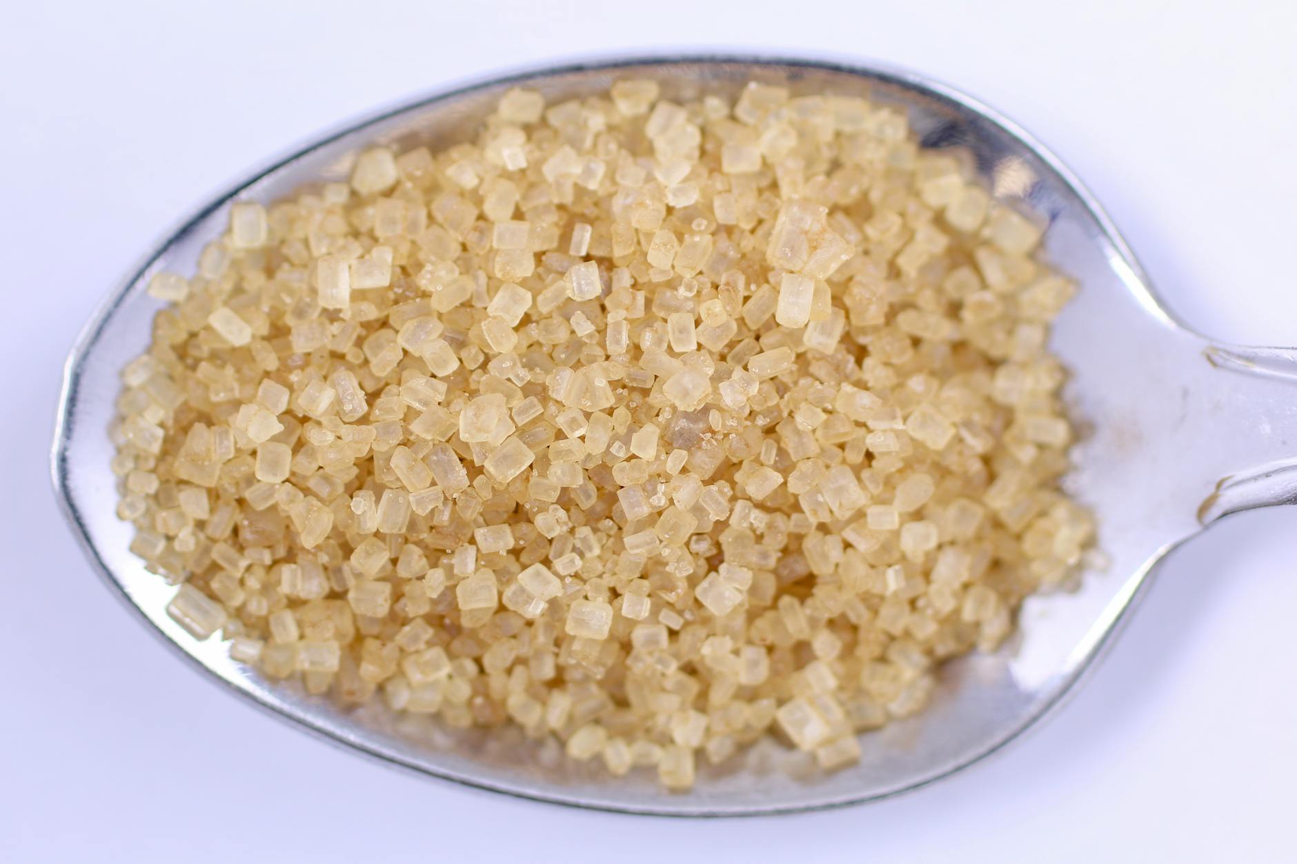 close up of raw brown sugar on spoon