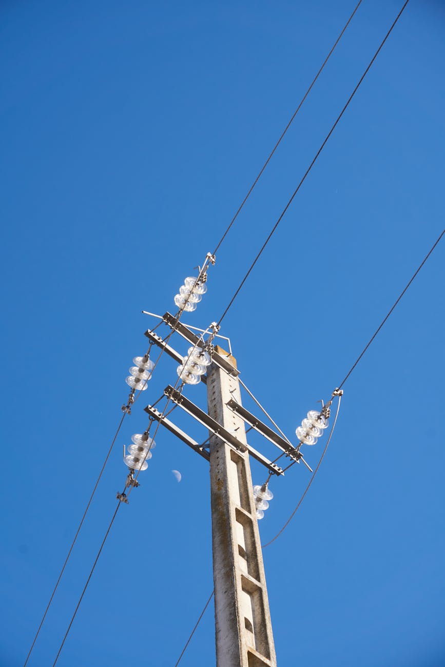 photograph of a utility pole under a blue sky