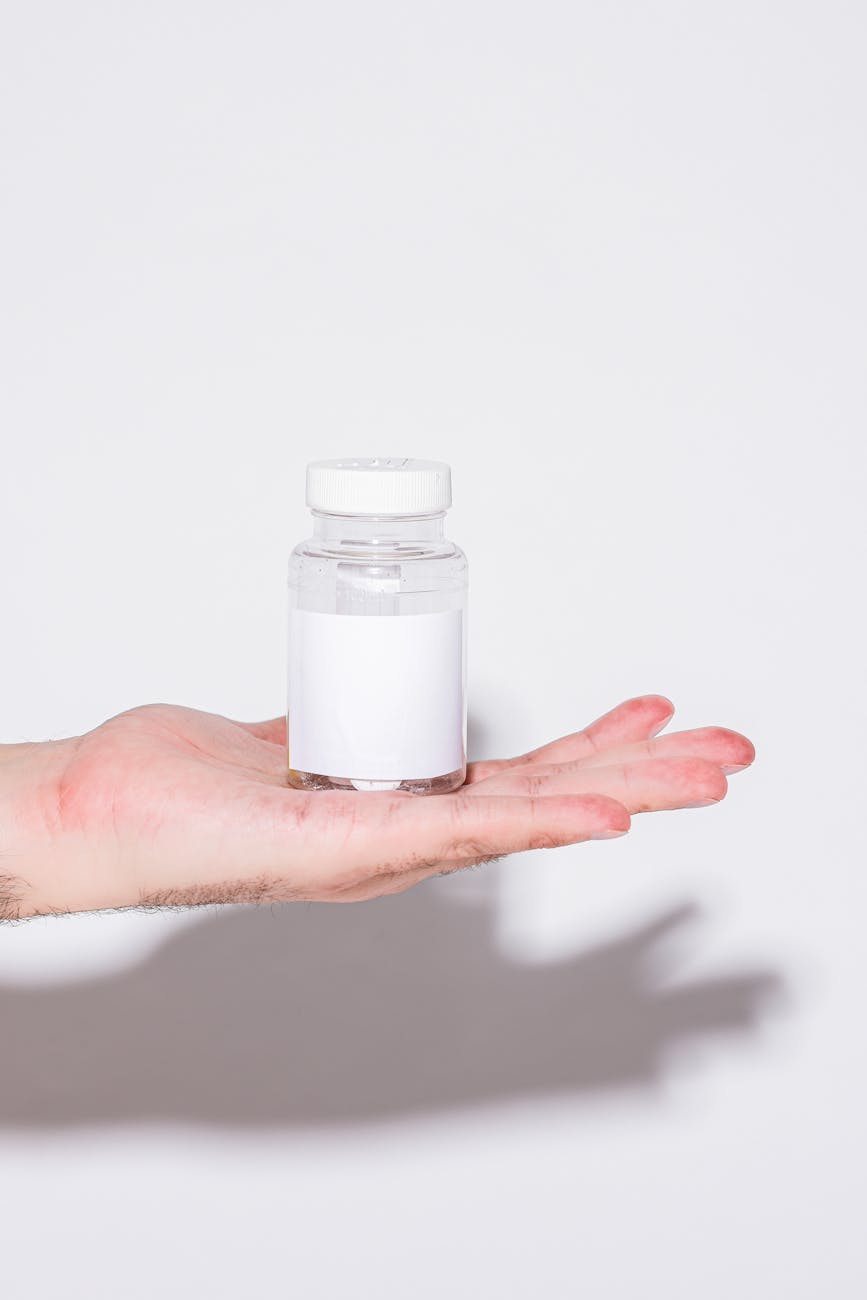 person holding a bottle with cream