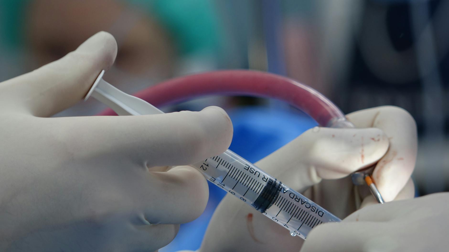 close up of syringe during surgery in operating room